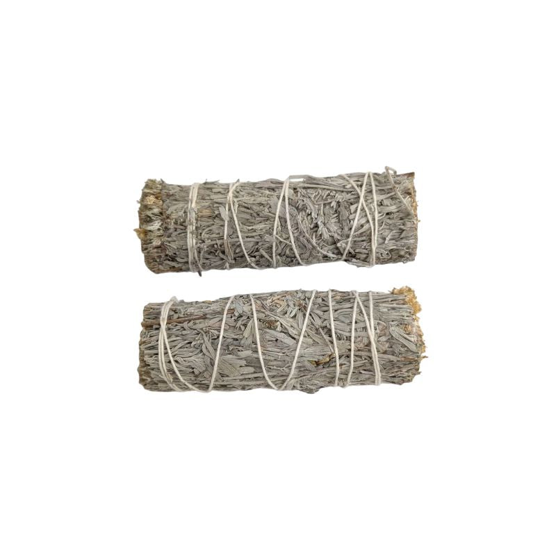 Two bundled blue sage smudge sticks wrapped in white string, displayed horizontally on a plain white background.
