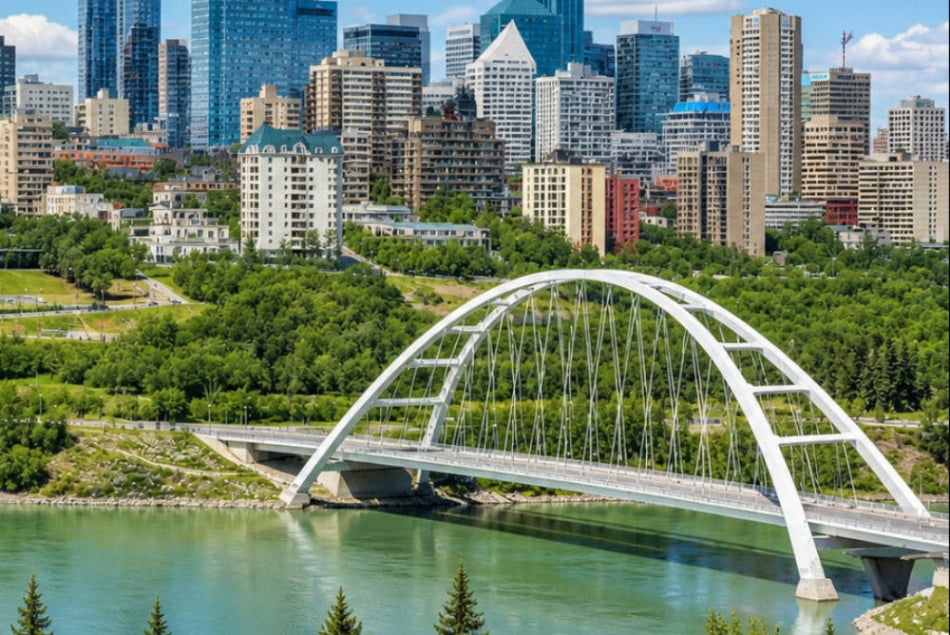 Edmonton Cityscape with a bridge over a river, surrounded by trees and buildings.