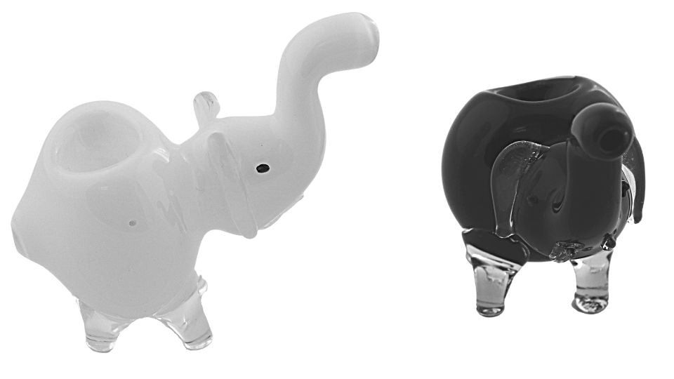 White and black elephant-shaped candle holders on a white background