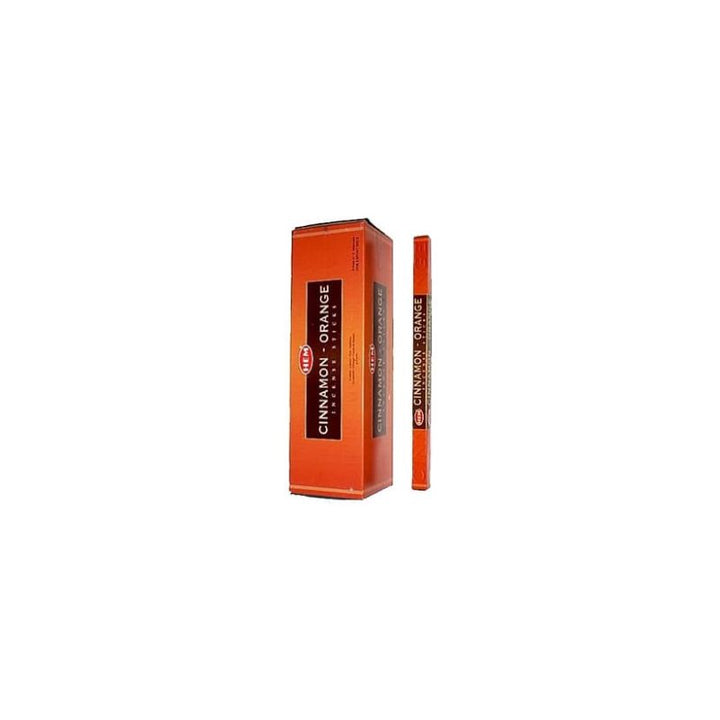 A cinnamon orange flavored product shown with its orange box and a matching orange stick/container standing beside it on a plain white background.