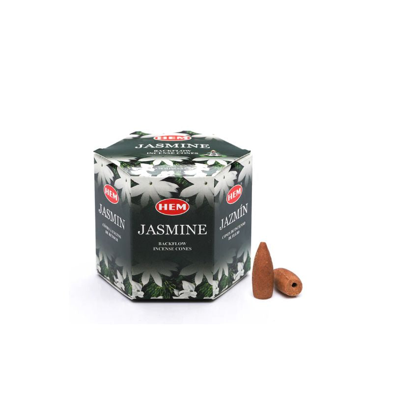 A box of HEM Jasmine incense coals with two small brown incense cones placed in front, set against a plain white background.