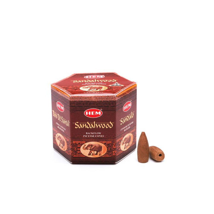 A box of HEM Sandalwood incense sticks with two brown cone incense sticks placed in front, set against a plain white background.