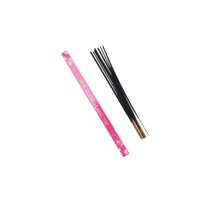 Hem ylang ylang incense sticks next to their pink paper packaging sleeve on a plain white background.