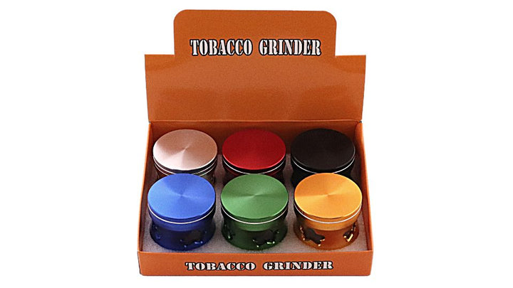 Box of colorful tobacco grinders with &