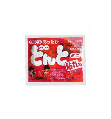 A packaged Japanese heating pad with a bright red and pink label featuring large white Japanese text and cartoon illustrations, photographed on a plain white background.