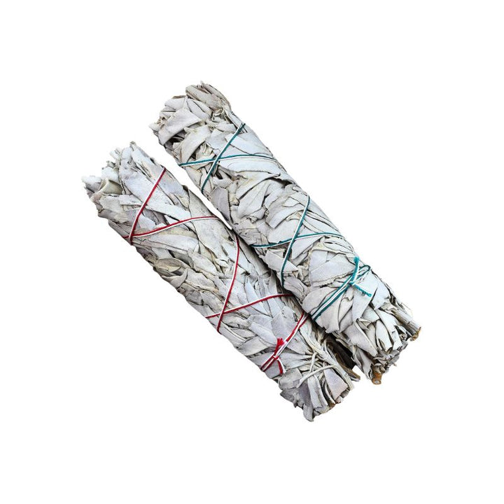 Two bundled white sage smudge sticks tied with red and green string, shown on a plain white background.