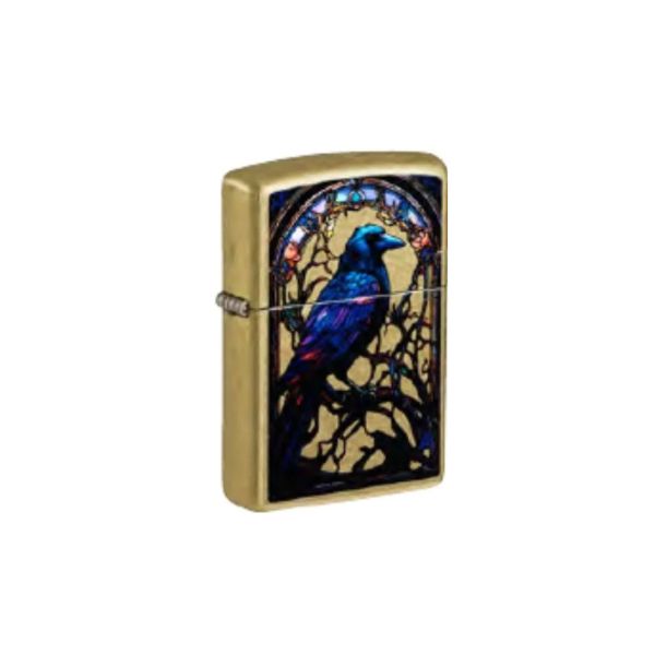 A gold-finished Zippo-style lighter with a stained-glass-style raven design on the front, shown against a plain white background.