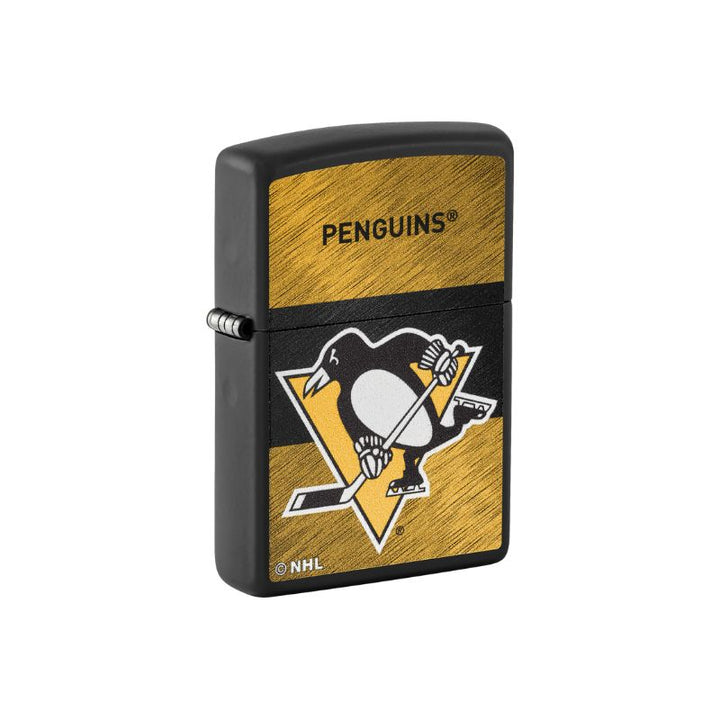 A black Zippo-style lighter featuring the Pittsburgh Penguins NHL logo and name on a gold brushed background, shown on a plain white background.