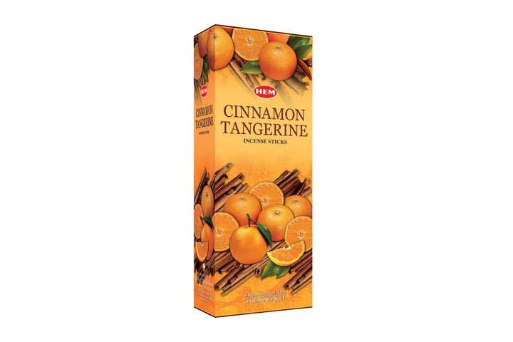Box of HEM Cinnamon Tangerine incense sticks with cinnamon sticks and tangerines on a white background