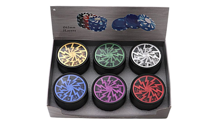Set of colorful grinder tops in a box with poker chip design in the background