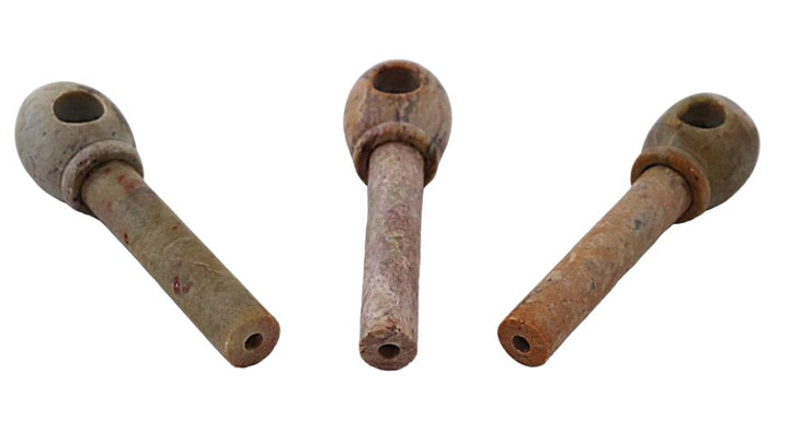 Stone tobacco pipes large on a white background