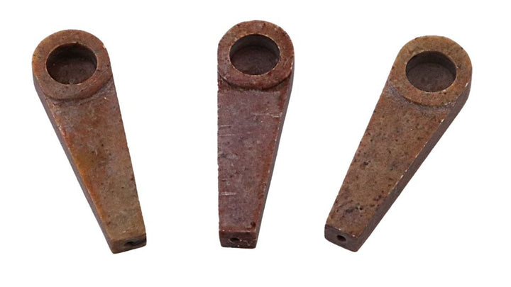 Stone tobacco pipes round on a white background
